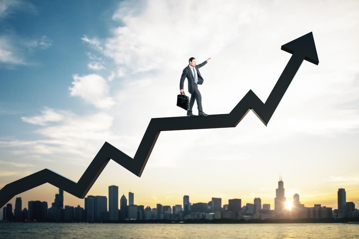 Businessman walking upwards rising growth arrow graph over city skyline