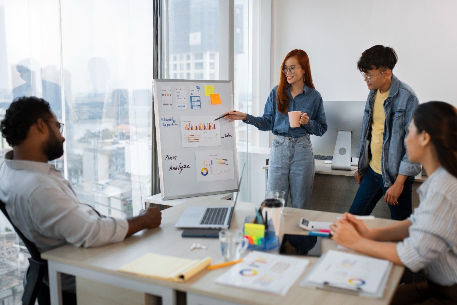 Female presenter whiteboard chart team meeting
