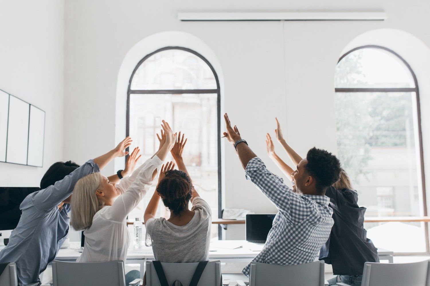 Office team raising hands stretching meeting