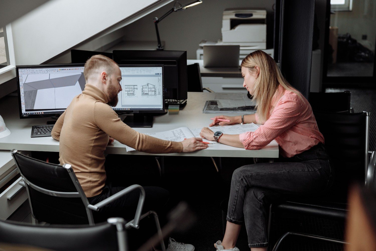 Interior designers collaborating at office desk