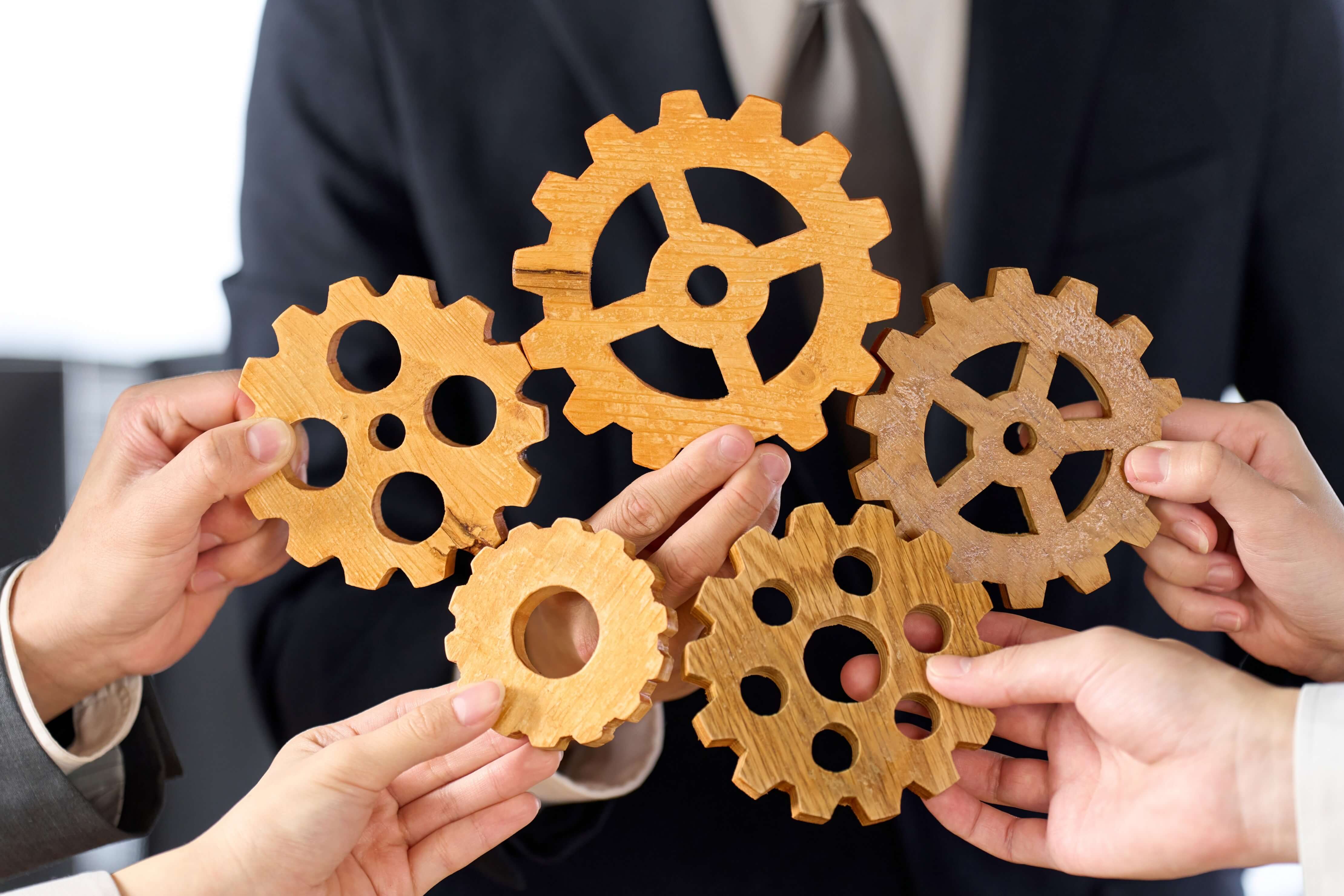 Business person with multiple gears
