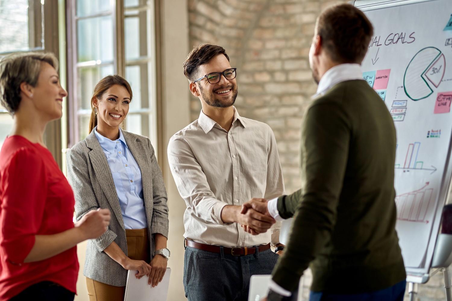 Business presentation with a partnership agreement handshake