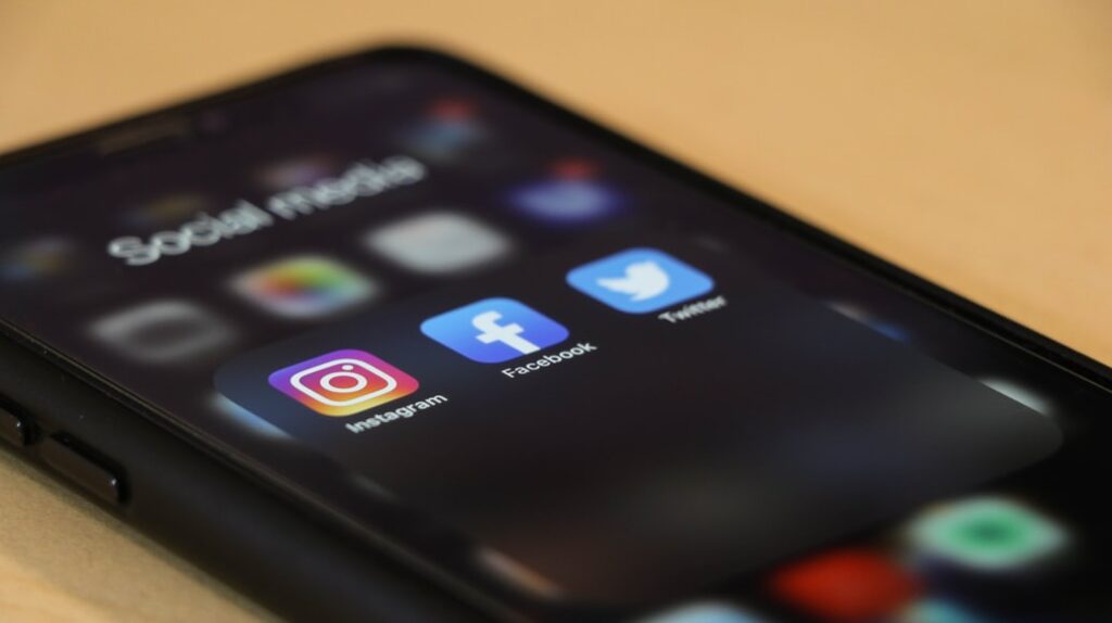 Mobile phone showing different social media platforms 1024x574