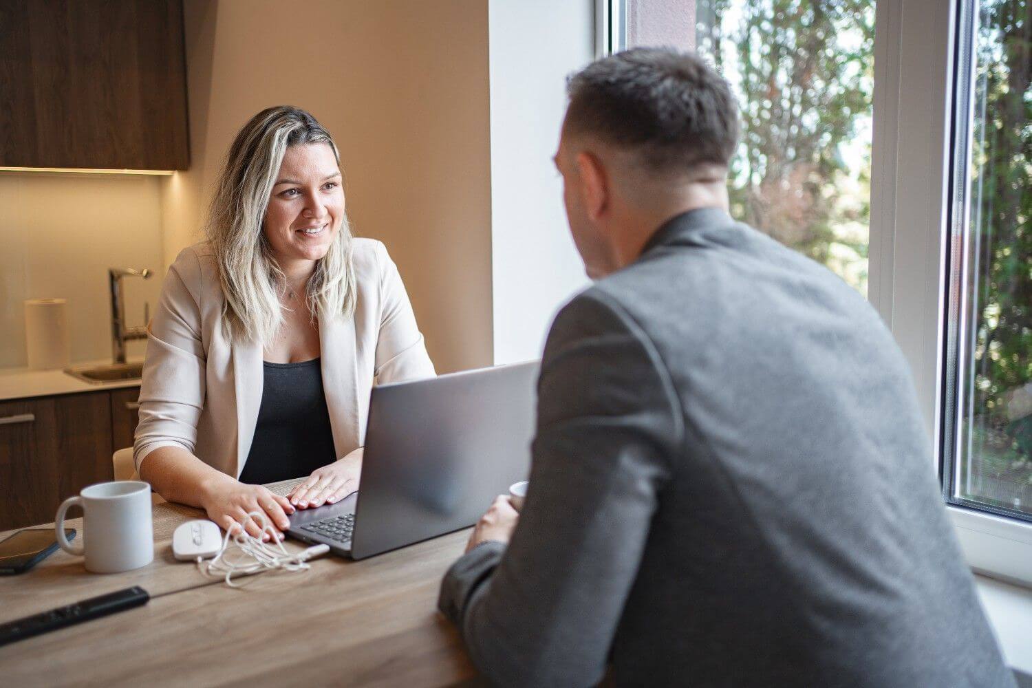 Owner and client working laptop table