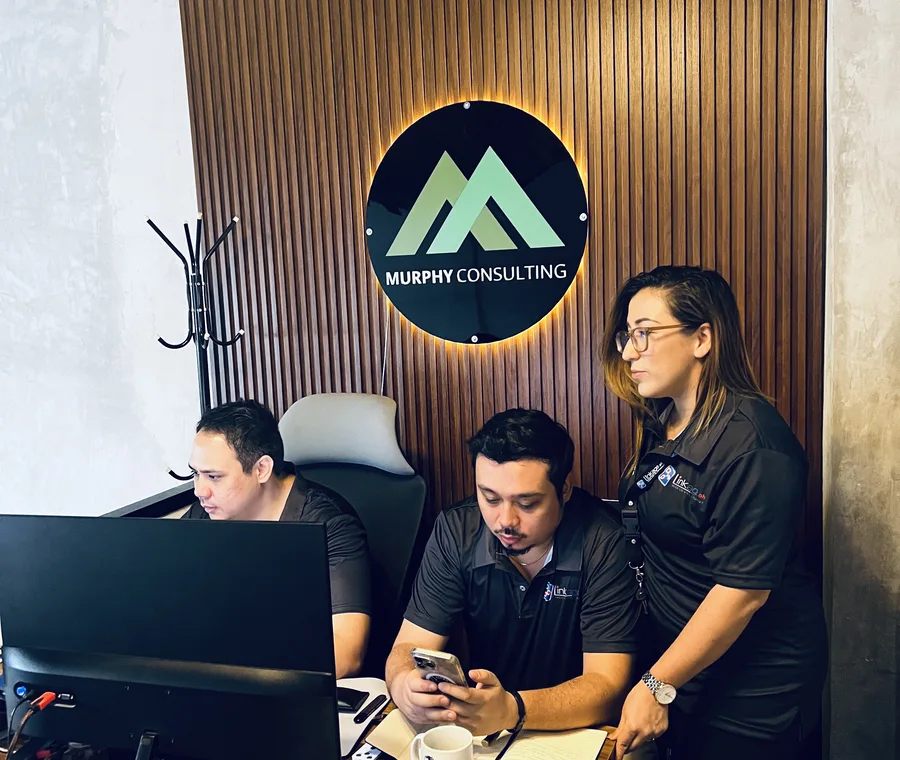 Murphy social team reviewing short-form content on a phone under the company logo