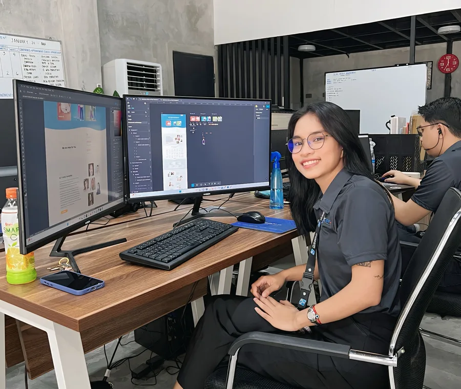 Murphy production developer building a website across dual monitors in the office