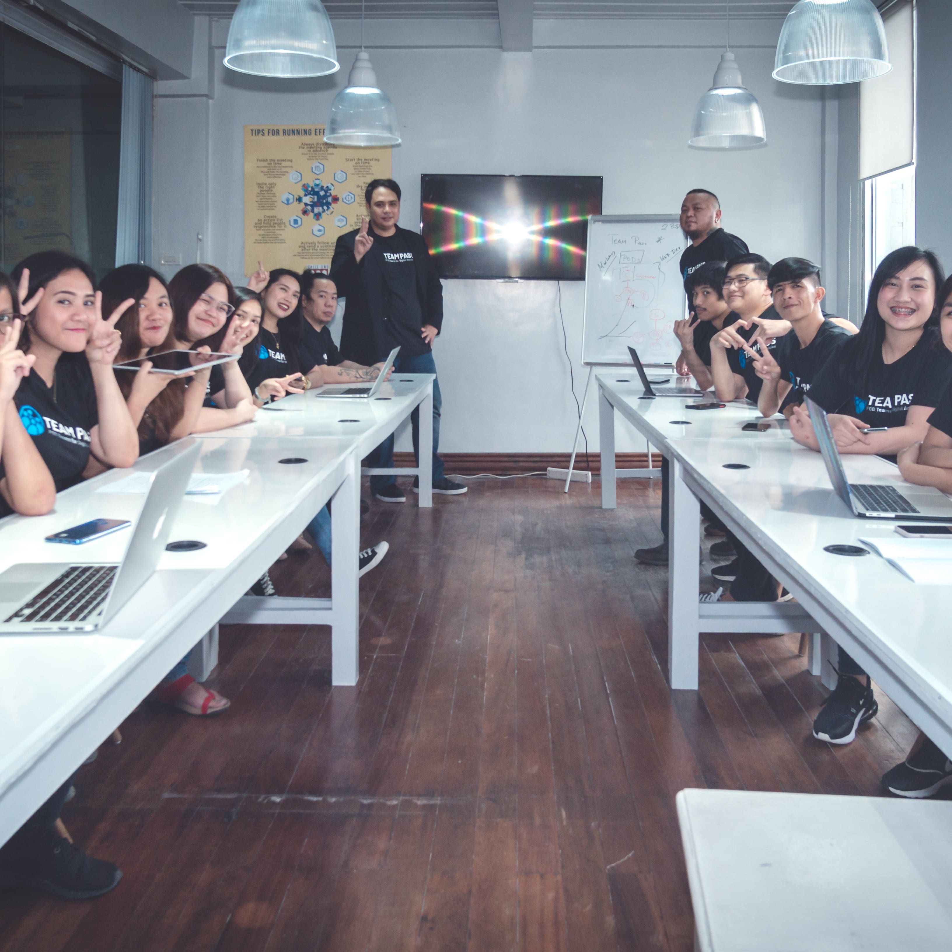 Team members seated in a training room for process review